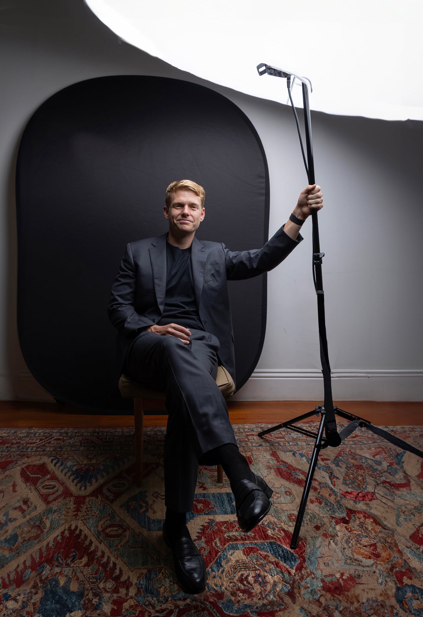Jacob Warwick, seated beside a studio light